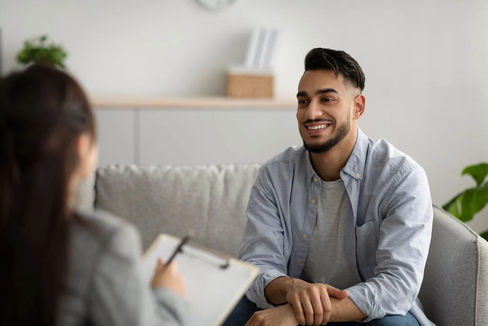 anger-management Man speaking with a therapist during counseling session for anger management in recovery.