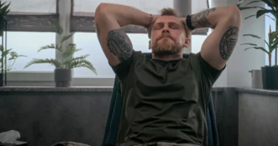 Man relaxing with eyes closed during trauma processing therapy and EMDR for addiction in San Diego.